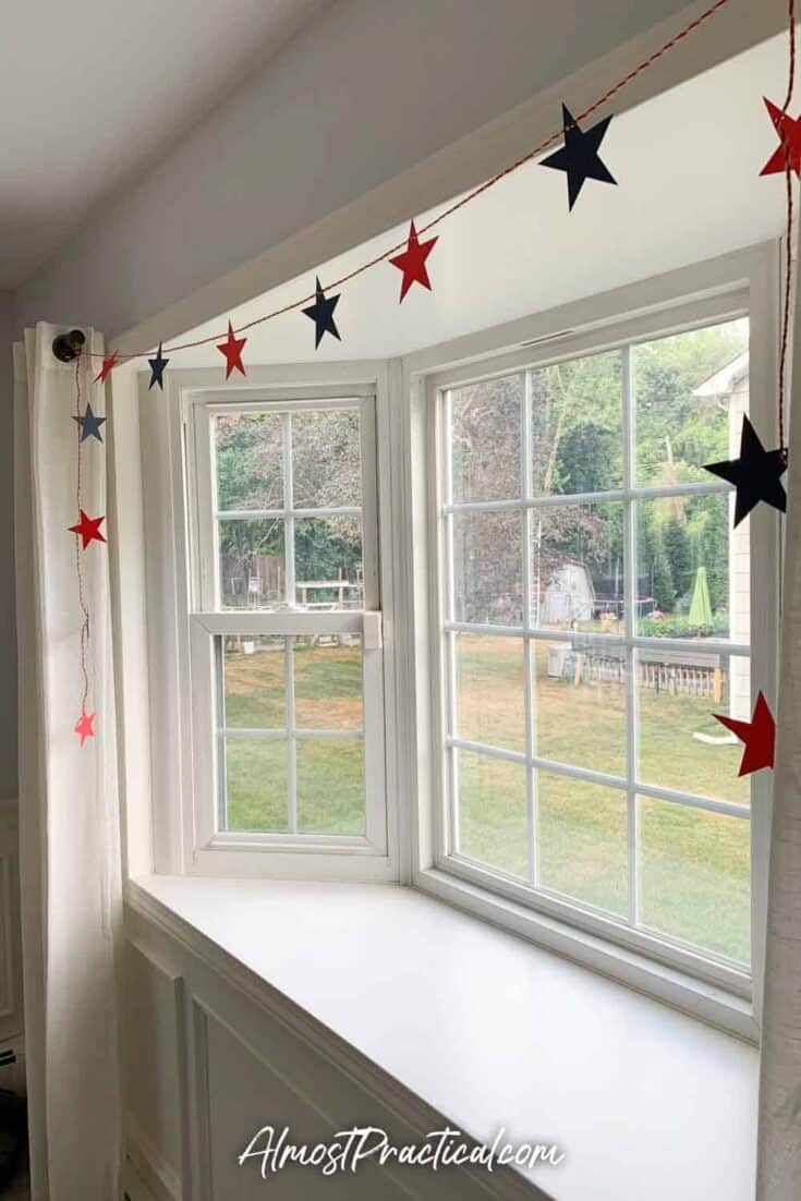 star garland draped over a bay window