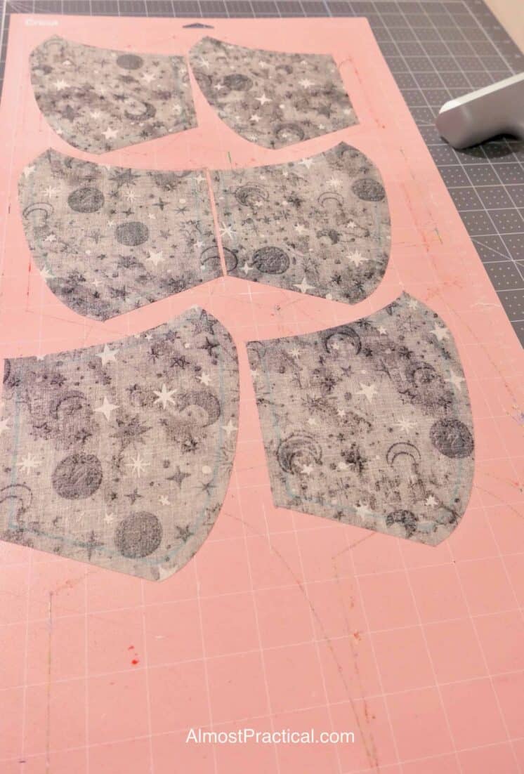 cut out face masks on a pink Cricut mat