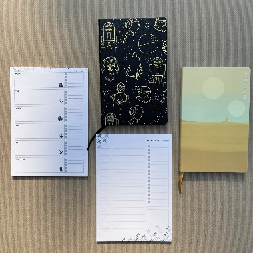 a set of note pads and Erin Condren Softbound notebooks featuring the Star Wars theme