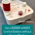 bobbin winder with red thread spool on a Cricut cutting mat