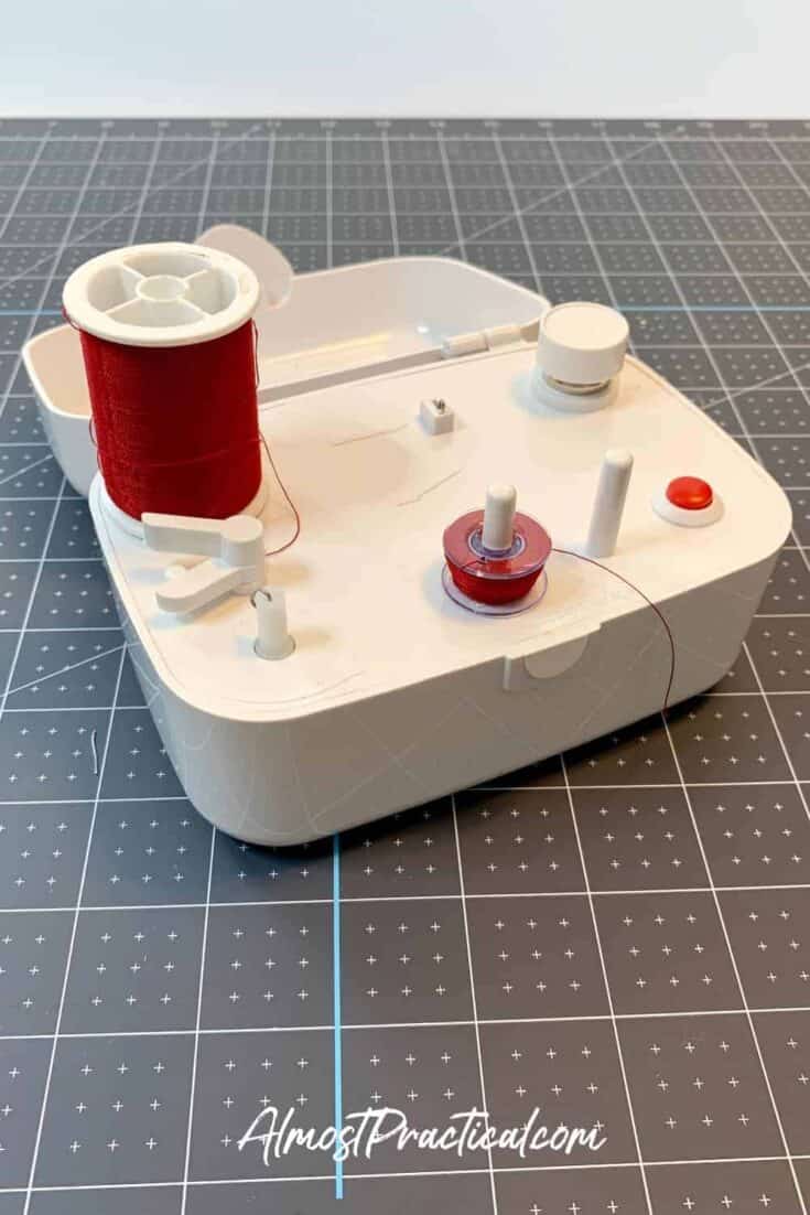 Bobbin winder sitting on the dark side of a Cricut self healing mat.