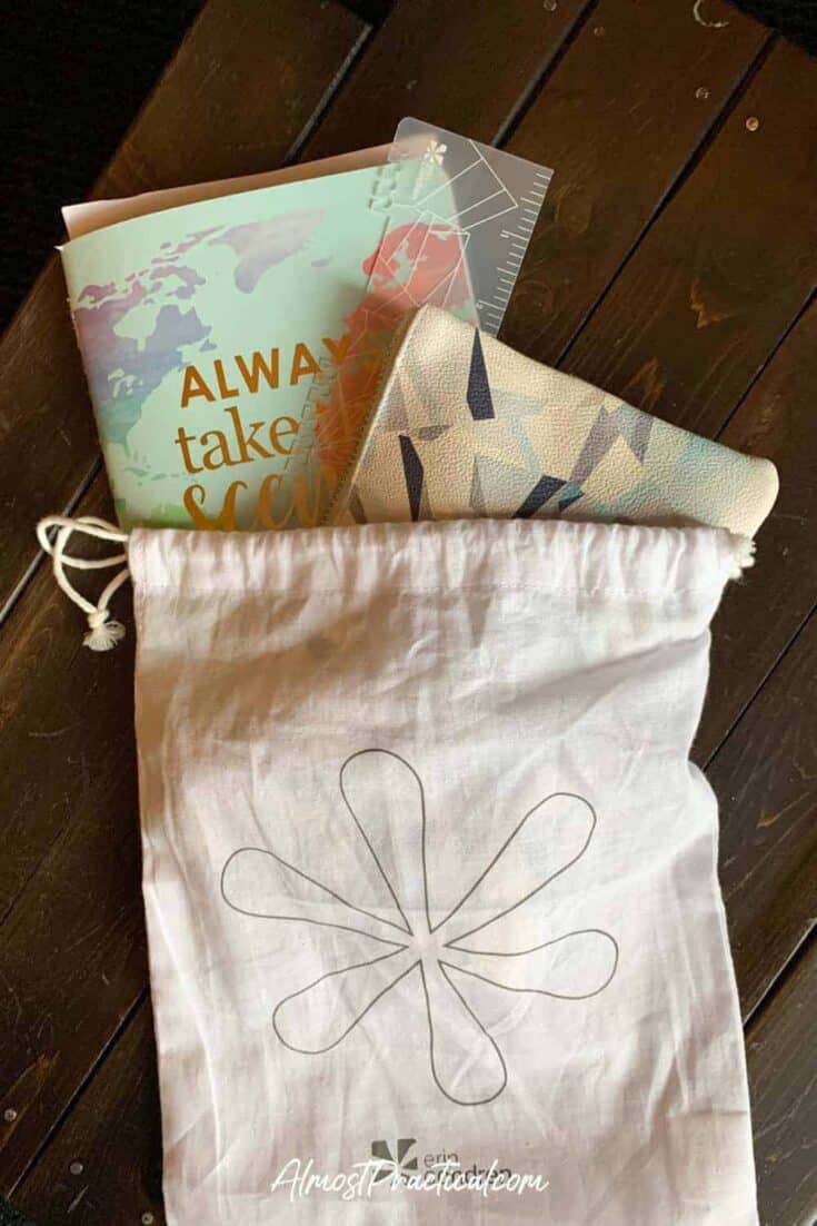 Erin Condren travel journal and planner accessories in a cream colored drawstring bag with Erin Condren logo on the front.