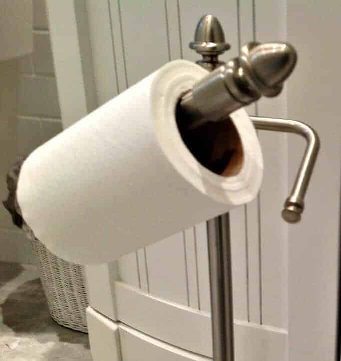 Toilet paper stand with pivot bar.