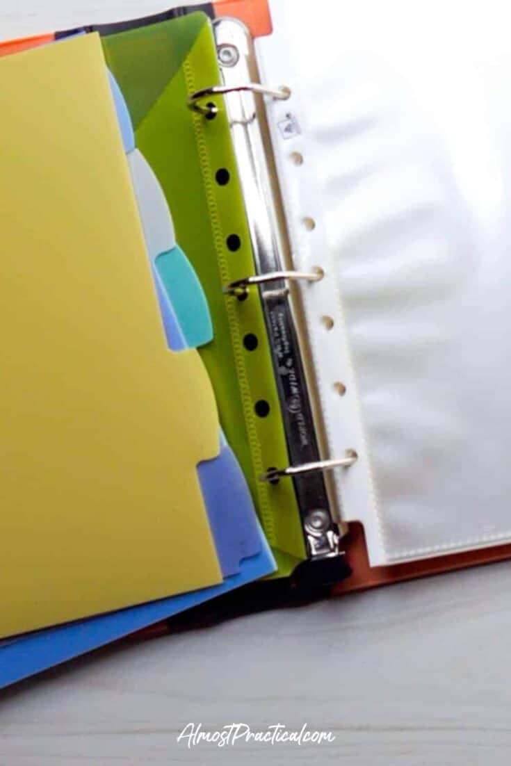 binder open to rings with dividers and sheet protectors shown