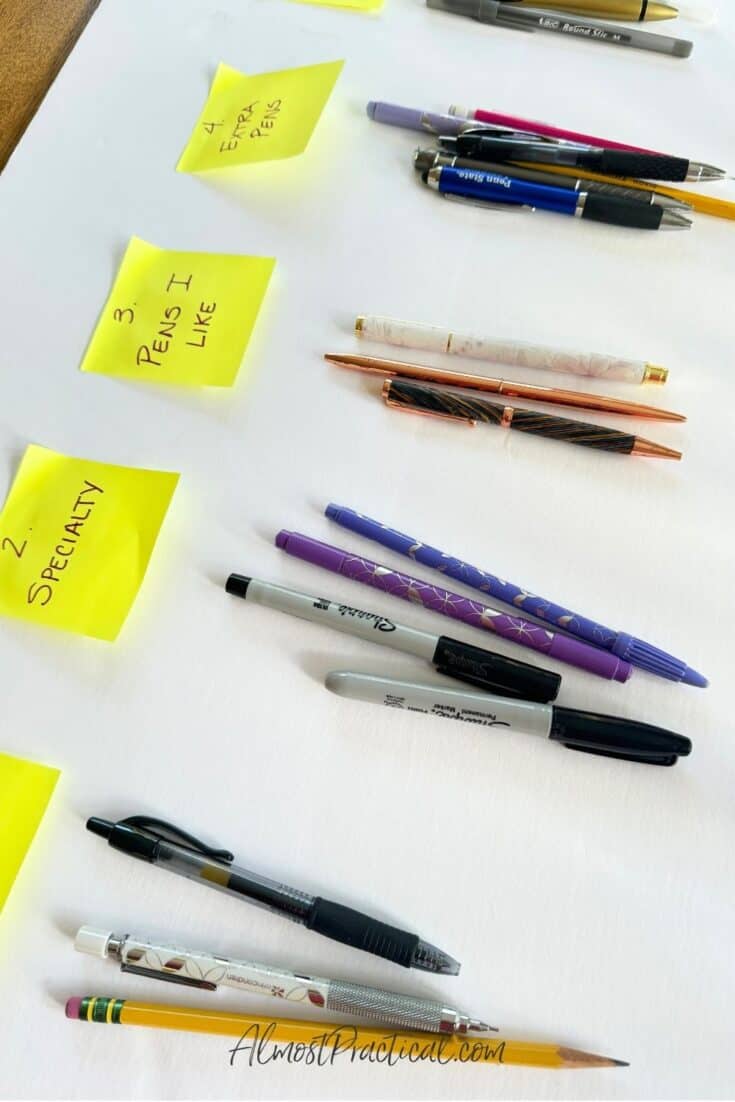 pens divided into groups based on categories listed on yellow sticky notes