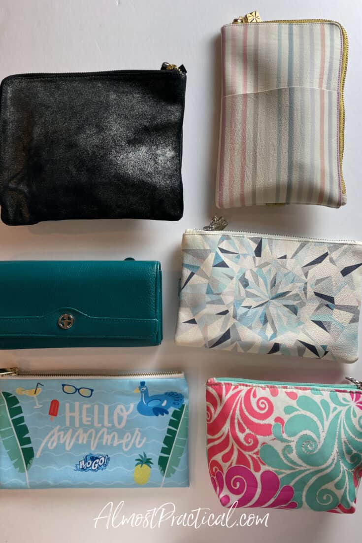 5 zippered pouches in different colorful patterns and one teal green wallet