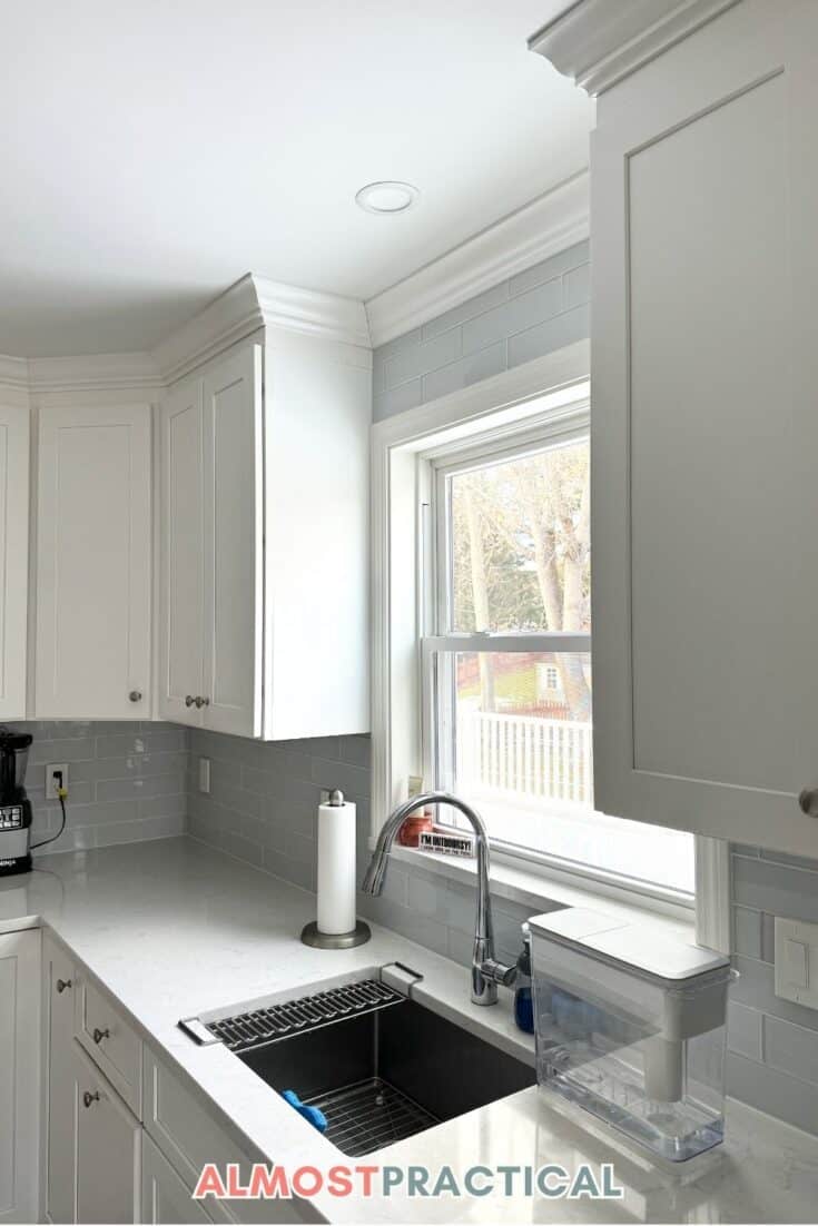 kitchen sink in kitchen with white countertops and cabinets